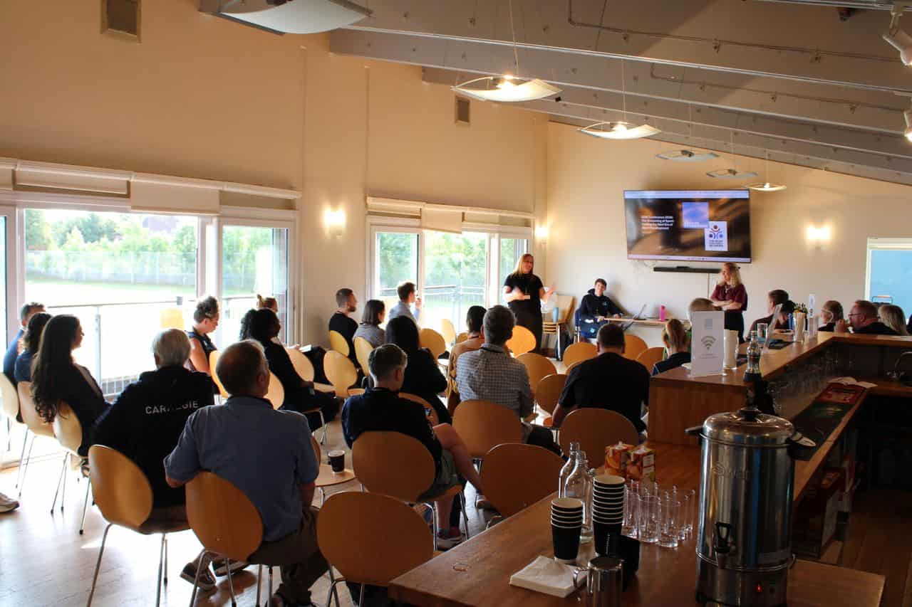 Audience attending a presentation at The Change Foundation event on Taekwondo 4 Change.